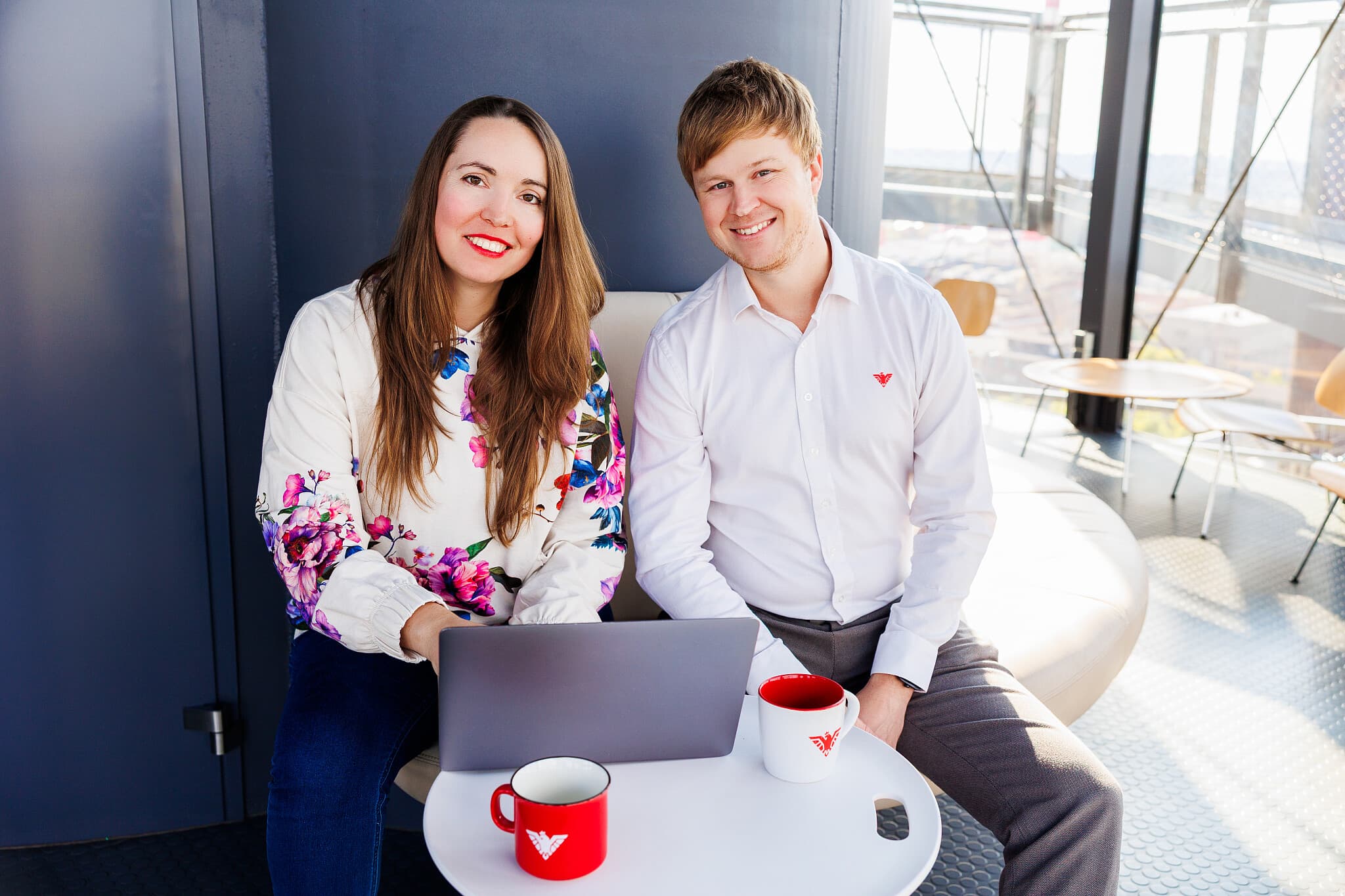 Two people from the Moravio team at a laptop
