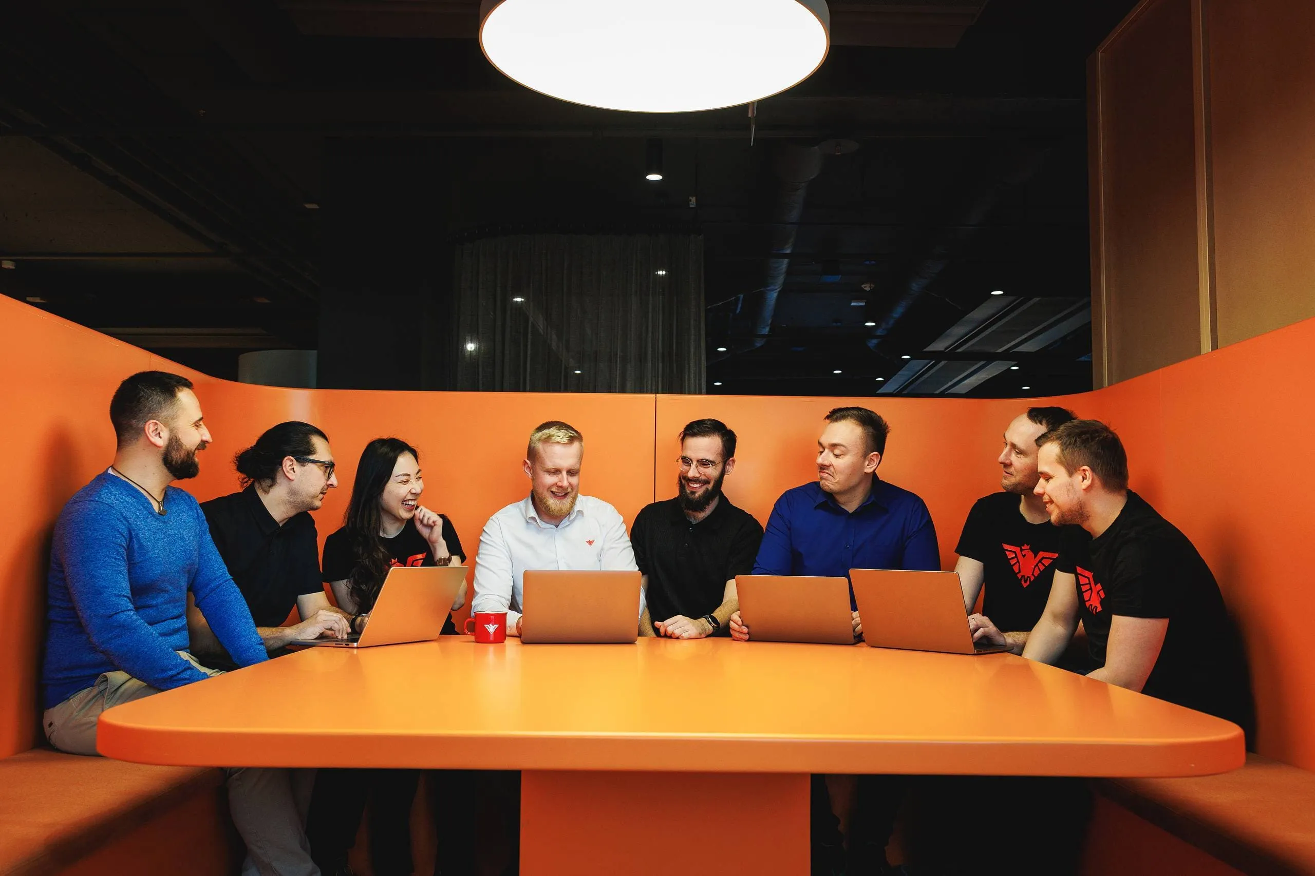 The Moravio team in a working meeting around a booth
